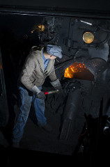 shoveling coal into the firebox