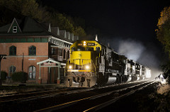 Four yellowjacket locomotives pass in front of the large brick starrucca house - station and hotel