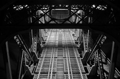 looking down onto the tracks of a bridge