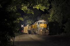 two gp35s cross a dirt road. The scene is wrapped by trees