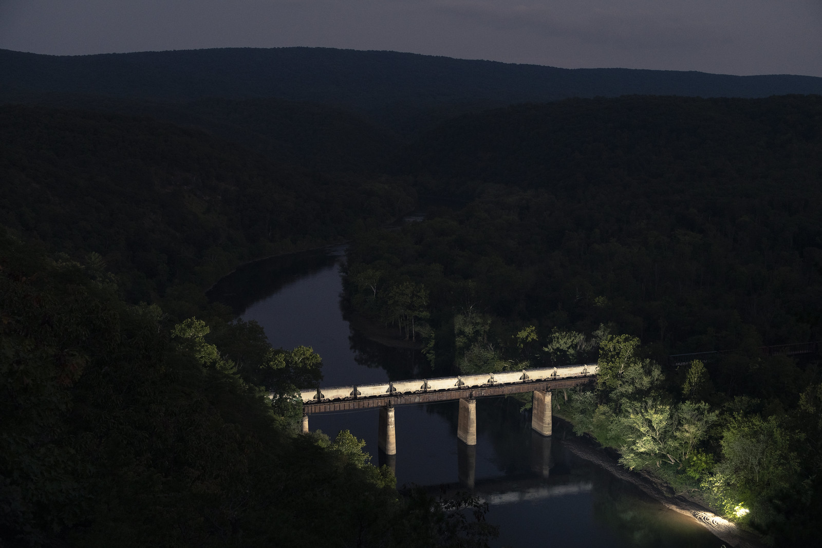 a train snakes along the Hudson River
