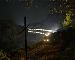 train snakes along a curve in a river