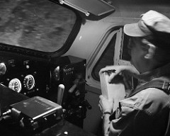 engineer checks paperwork in the locomotive cab