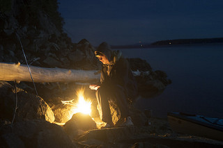 campfire on the rocky shore of a lake