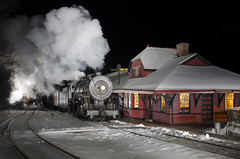 steam train at a depot at night